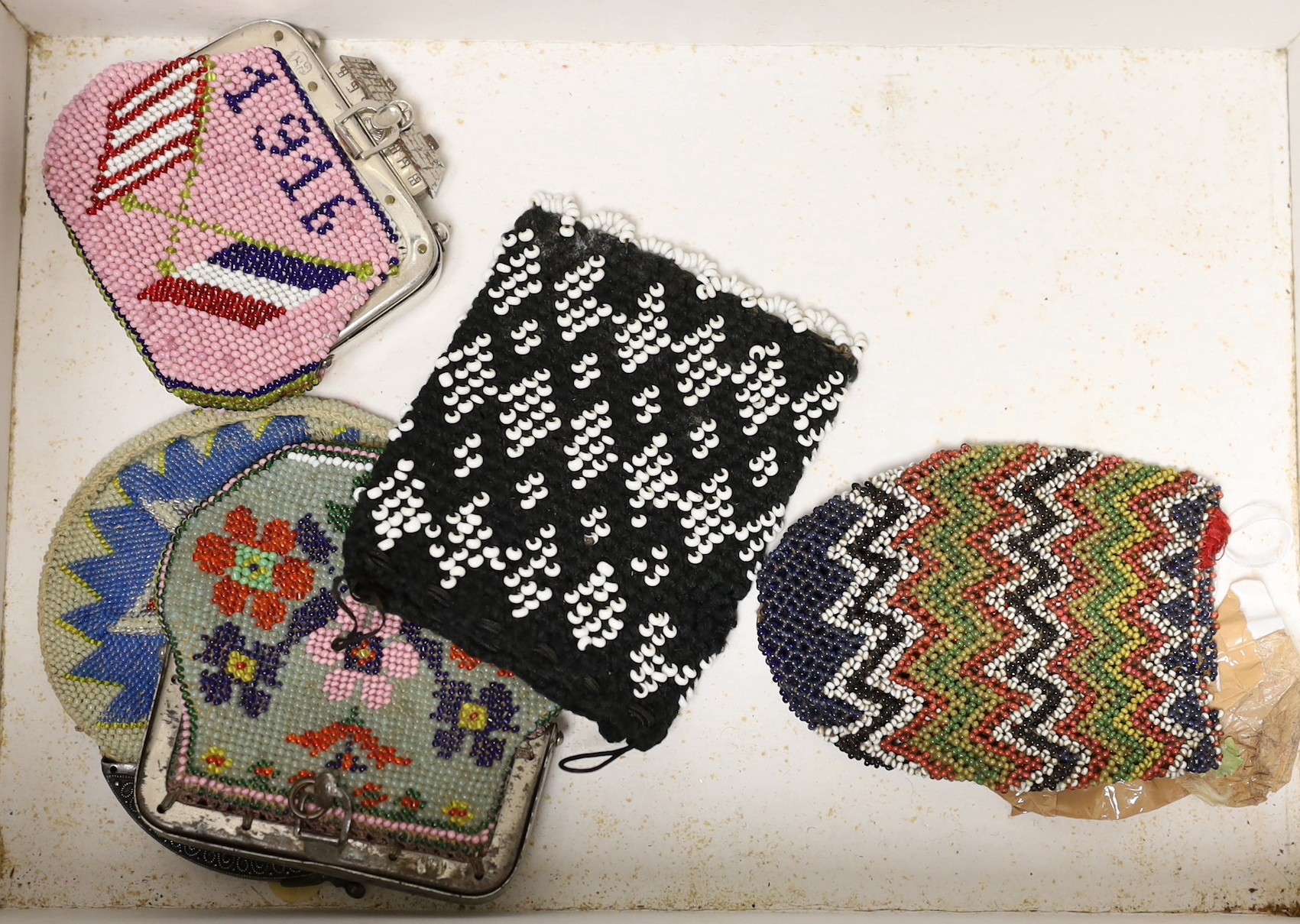 A collection of beadwork purses and bags from early 1900’s, including a W W I bead-worked purse dated 1916 with a steel frame surmounted with a building as the clasp, three beadwork bible bags, five beadwork purses and a